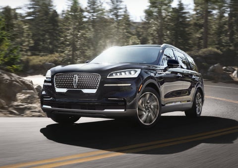 A Lincoln Aviator® SUV is being driven on a winding mountain road | Lidtke Lincoln in Beaver Dam WI