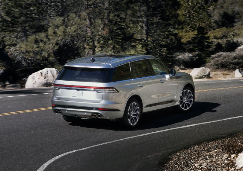 A 2023 Lincoln Aviator® Grand Touring model is shown being driven on a tight turn of a mountain road | Lidtke Lincoln in Beaver Dam WI