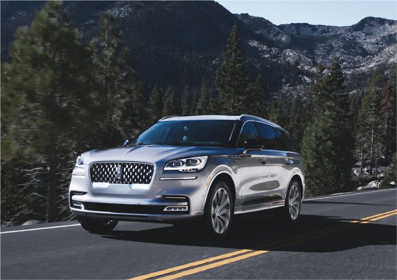 A 2023 Lincoln Aviator® Grand Touring SUV being driven on a winding road to demonstrate the capabilities of all-wheel drive | Lidtke Lincoln in Beaver Dam WI