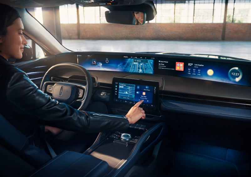 The driver of a 2024 Lincoln Nautilus® SUV interacts with the center touchscreen. | Lidtke Lincoln in Beaver Dam WI